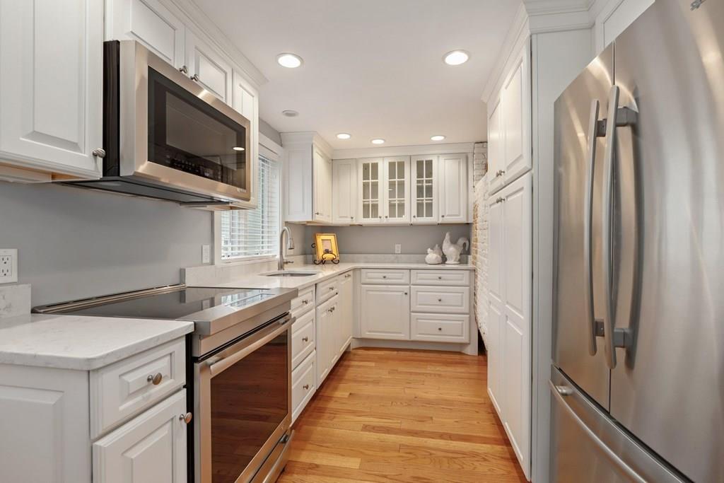 434 Main Street Amesbury, MA 01913 - Photo 4 of 40 a kitchen with stainless steel appliances granite countertop a refrigerator and a sink