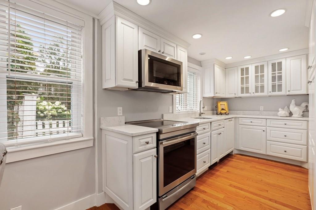 434 Main Street Amesbury, MA 01913 - Photo 5 of 40 a kitchen with granite countertop stainless steel appliances a stove sink and microwave