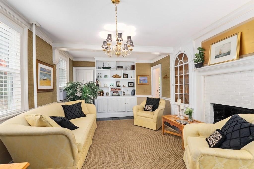 434 Main Street Amesbury, MA 01913 - Photo 10 of 40 a living room with furniture chandelier and a fireplace