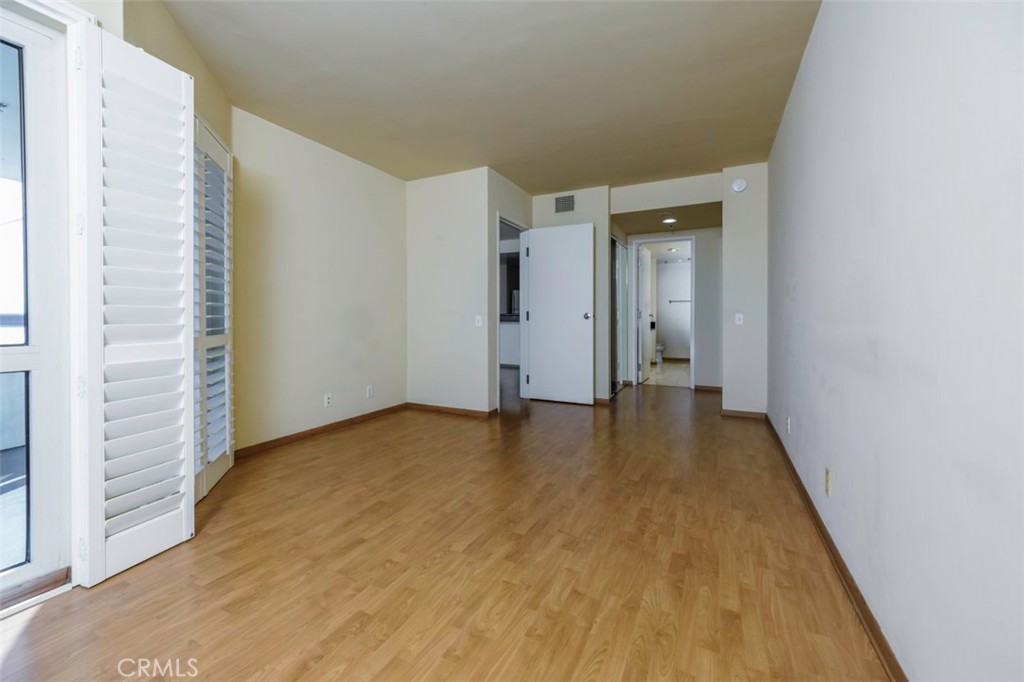 525 East Seaside Way, Unit 704 Long Beach, CA 90802 - Photo 17 of 38 a view of an empty room with wooden floor and a window