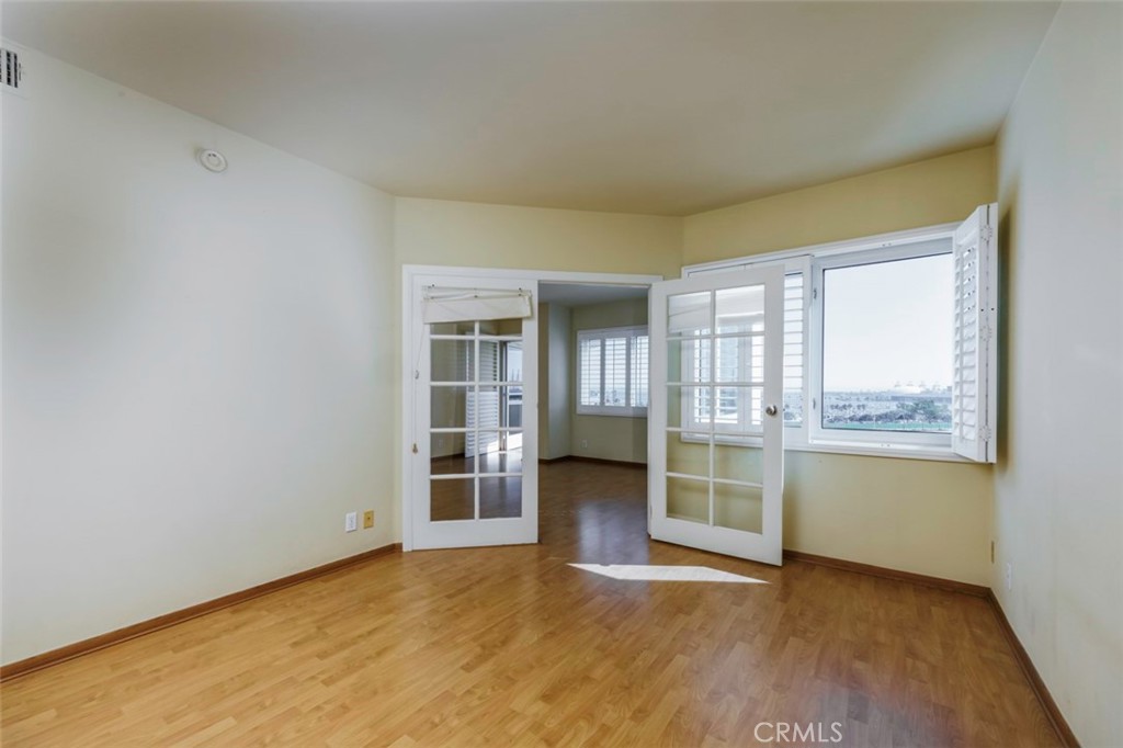 525 East Seaside Way, Unit 704 Long Beach, CA 90802 - Photo 22 of 38 an empty room with a fireplace and wooden floor