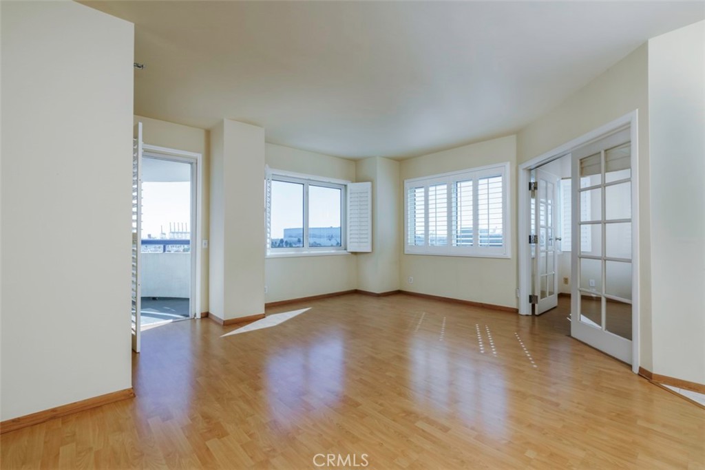 525 East Seaside Way, Unit 704 Long Beach, CA 90802 - Photo 3 of 38 an empty room with wooden floor and windows