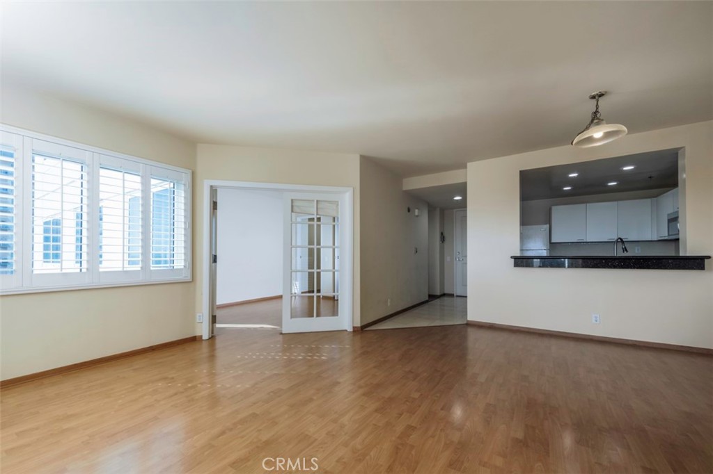 525 East Seaside Way, Unit 704 Long Beach, CA 90802 - Photo 10 of 38 an empty room with wooden floor and windows
