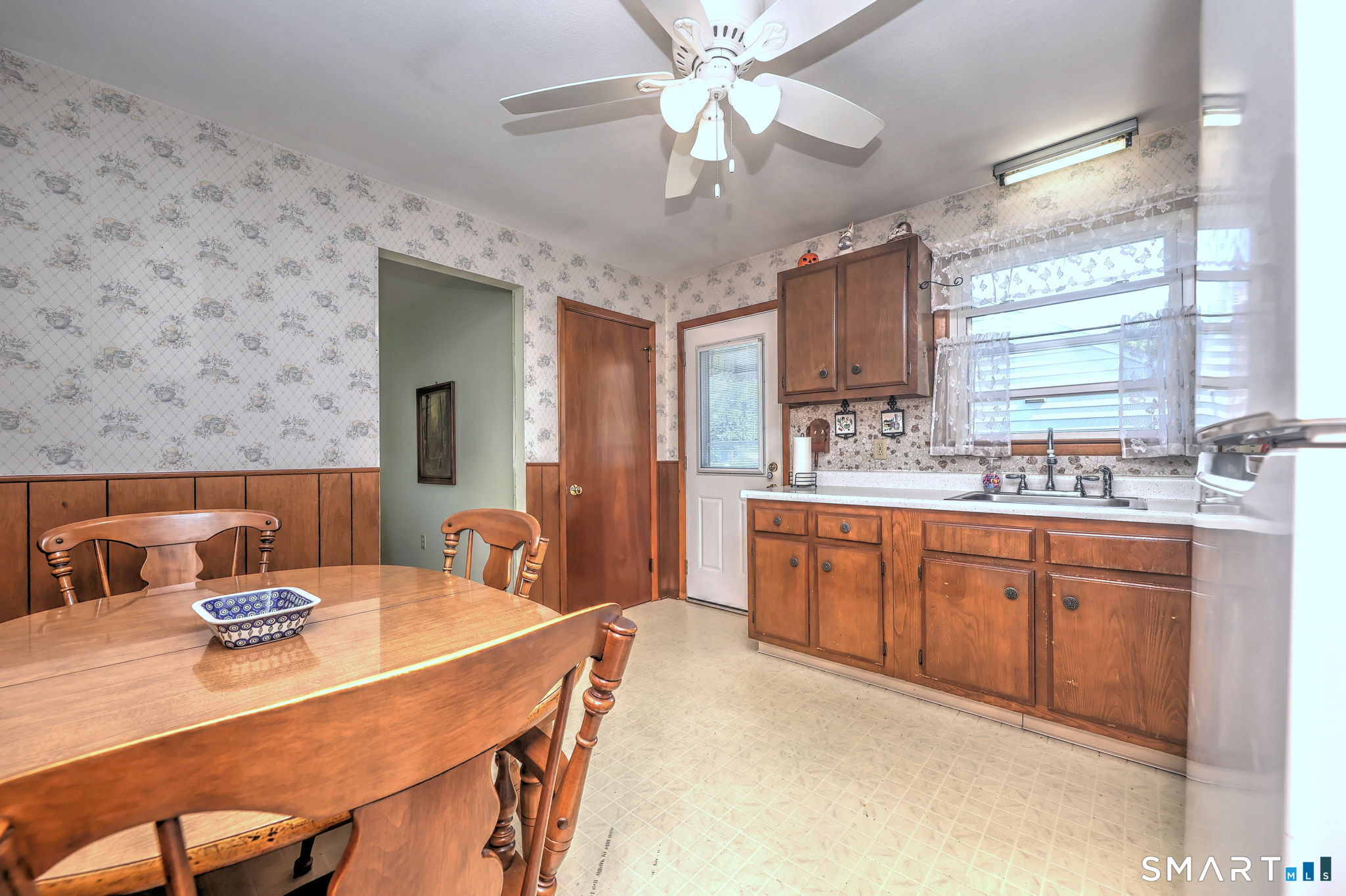 212 Swain Avenue Meriden, CT 06450 - Photo 19 of 38 a spacious kitchen with stainless steel appliances granite countertop a sink a stove a dining table and chairs