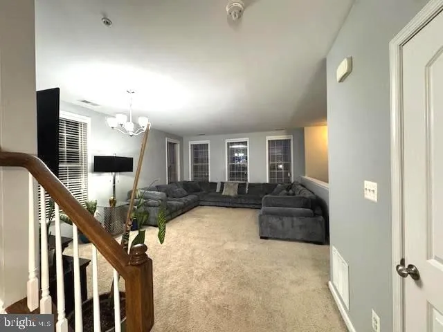 a view of a livingroom with furniture and hardwood floor