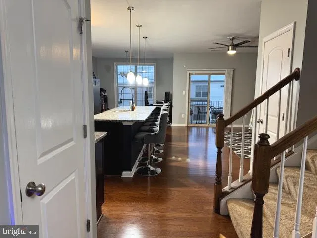 a room with furniture pool table wooden floor and windows