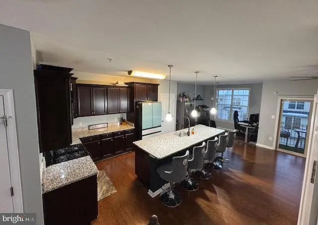 a kitchen with a sink a counter space appliances and cabinets