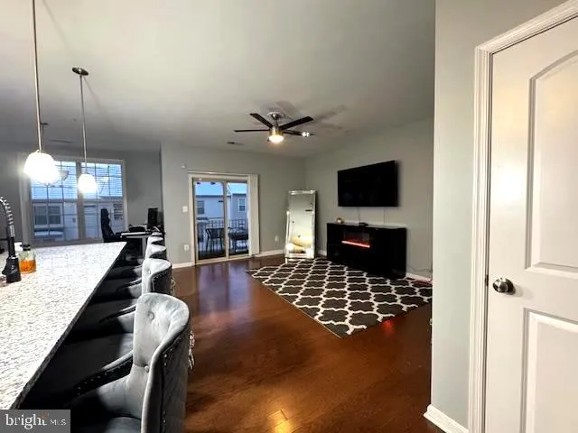 a living room with lots of furniture and kitchen view