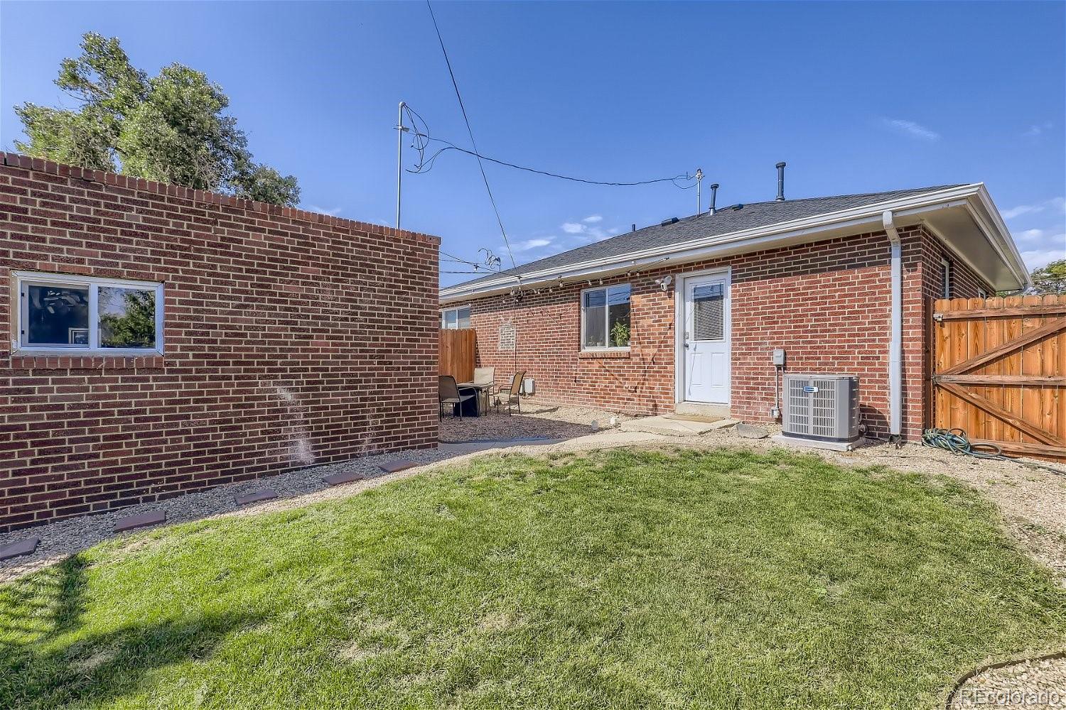 3456 Harrison Street Denver, CO 80205 - Photo 11 of 11 a front view of a house with a yard