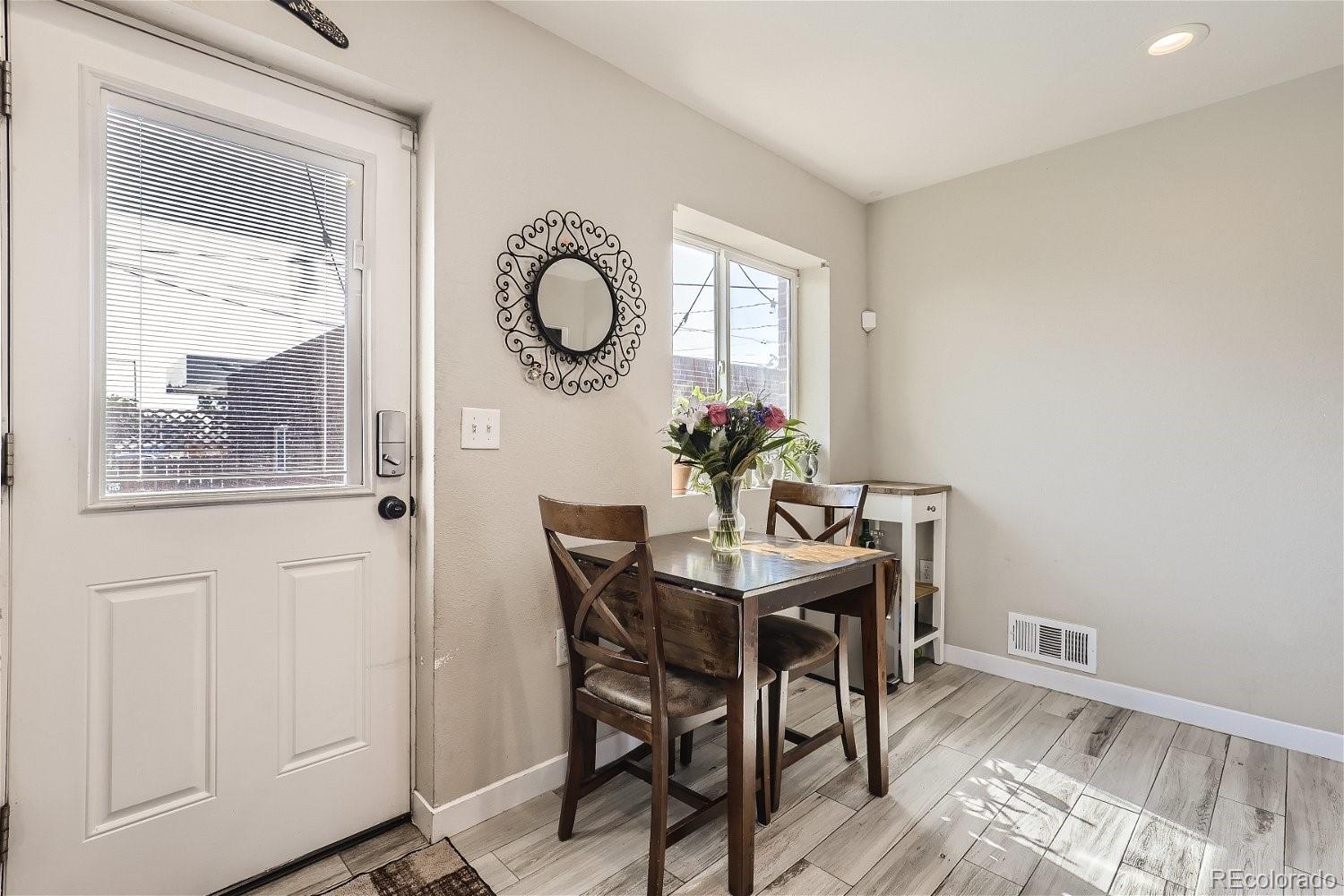 3456 Harrison Street Denver, CO 80205 - Photo 5 of 11 a view of a dining room with furniture and chandelier