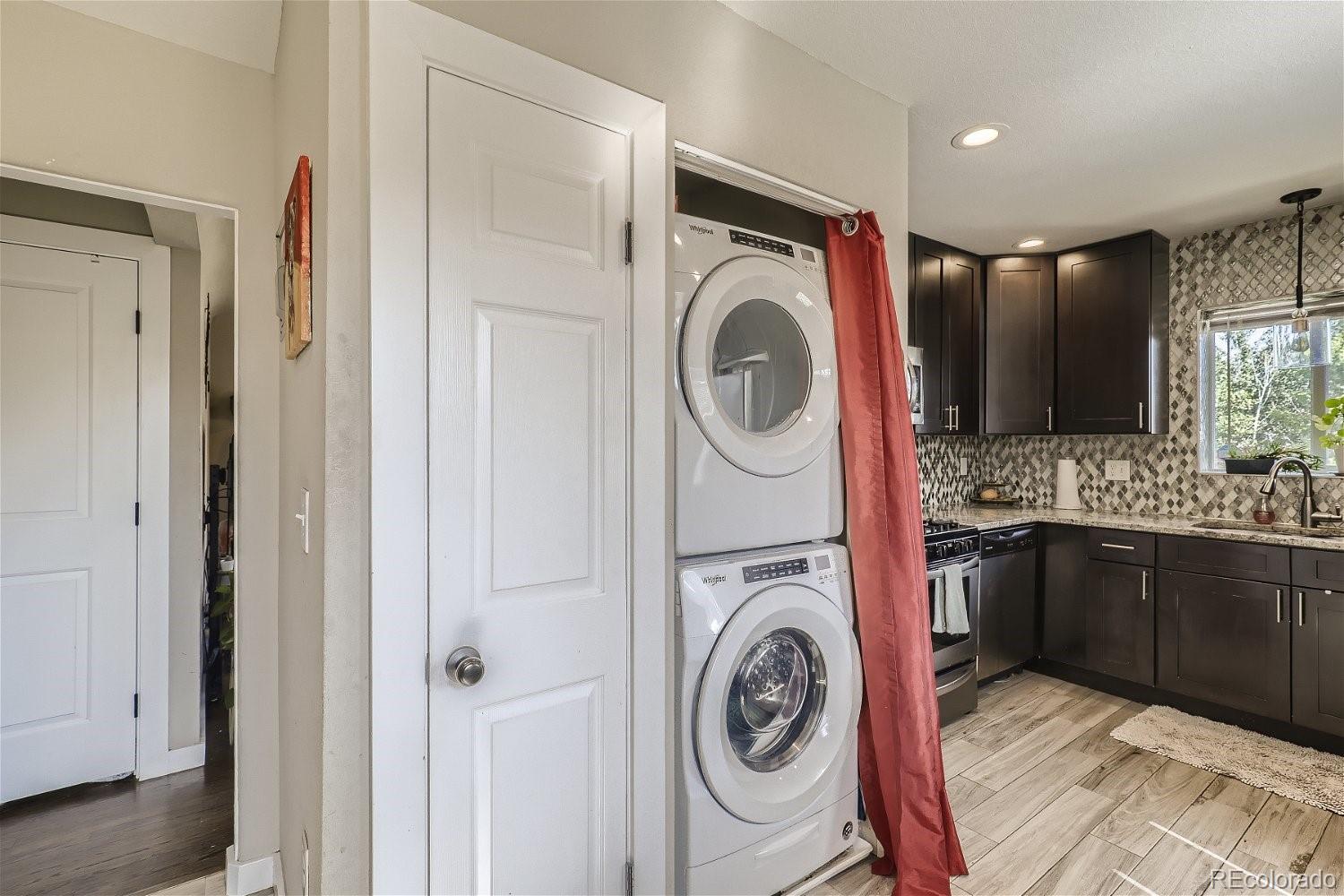 3456 Harrison Street Denver, CO 80205 - Photo 9 of 11 a utility room with sink dryer and washer
