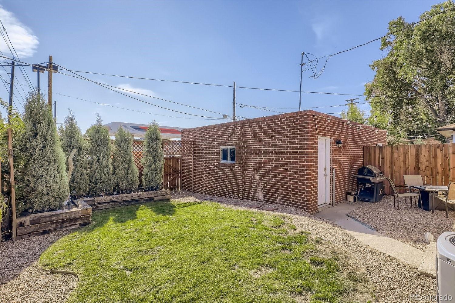 3456 Harrison Street Denver, CO 80205 - Photo 10 of 11 a backyard of a house with table and chairs