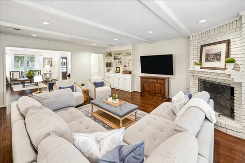a living room with fireplace furniture and a flat screen tv