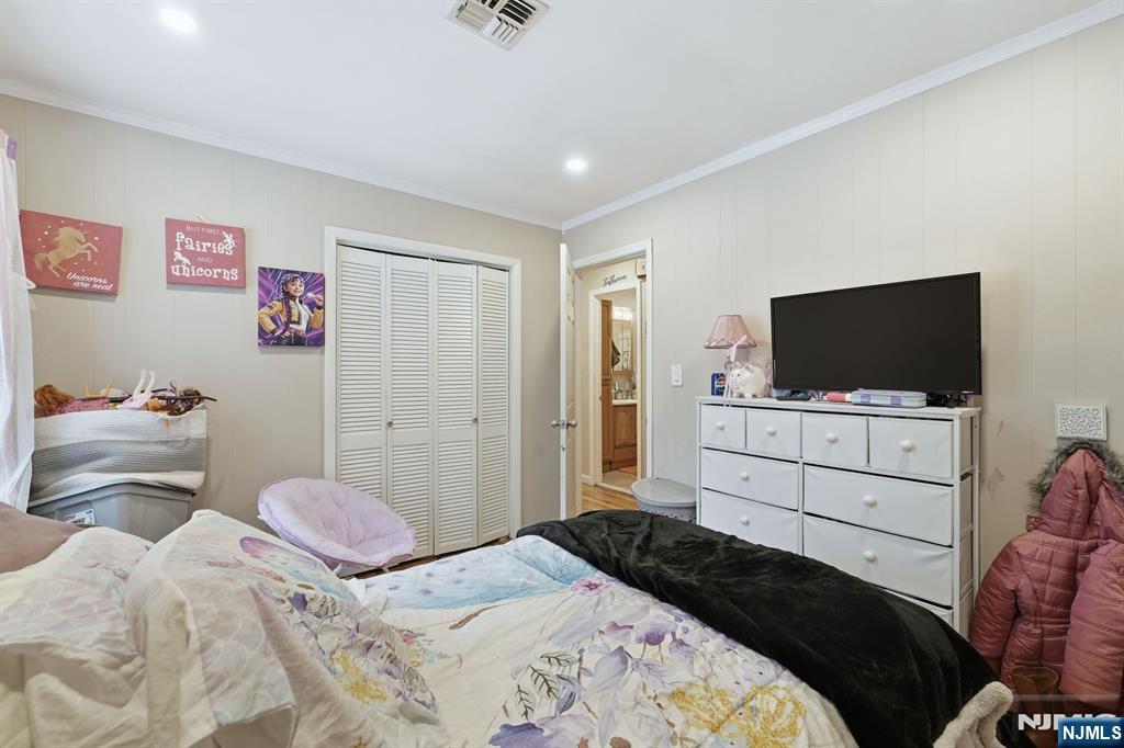 587 Marlboro Road Old Bridge, NJ 08857 - Photo 18 of 36 a bedroom with a bed and a flat screen tv