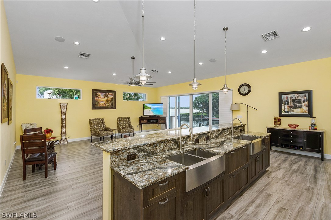 2743 Janet Street Cape Coral, FL 33993 - Photo 11 of 35 a large kitchen with stainless steel appliances a large counter top a stove a sink and a refrigerator