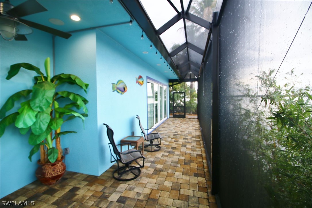 2743 Janet Street Cape Coral, FL 33993 - Photo 14 of 35 a view of a porch with chairs and a potted plant