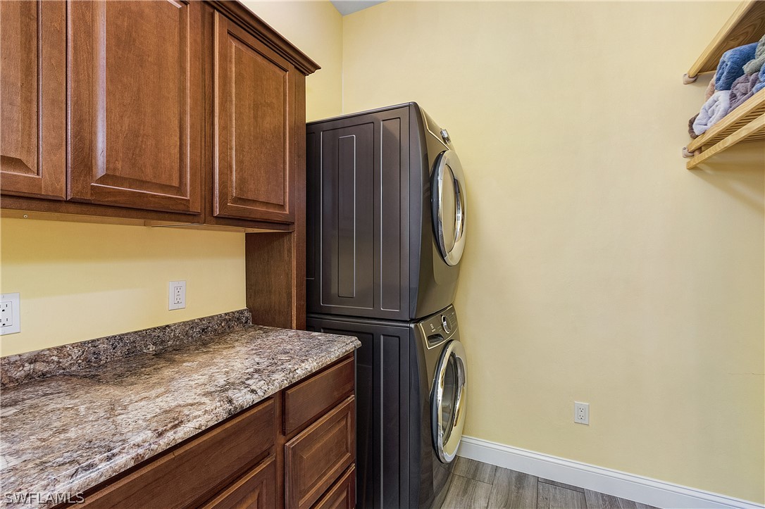 2743 Janet Street Cape Coral, FL 33993 - Photo 17 of 35 a kitchen with granite countertop cabinets and black appliances