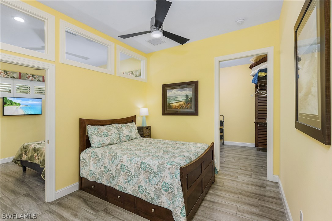 2743 Janet Street Cape Coral, FL 33993 - Photo 18 of 35 a bedroom with a bed and wooden floor