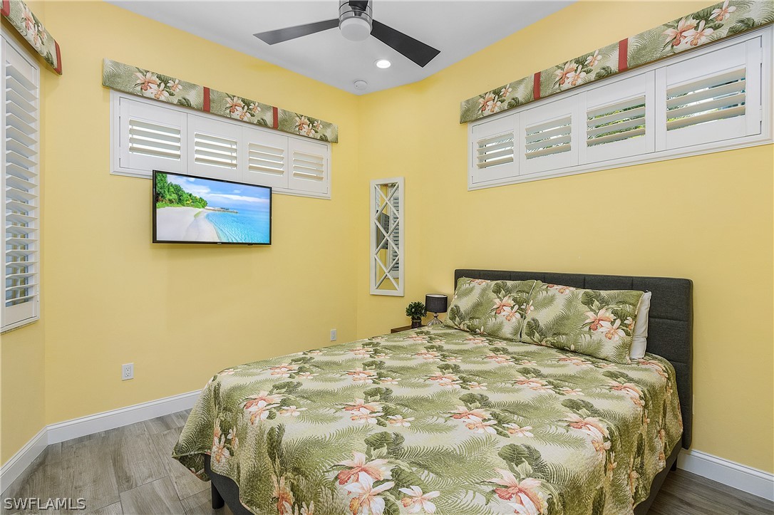 2743 Janet Street Cape Coral, FL 33993 - Photo 19 of 35 a bedroom with a bed and a painting on the wall