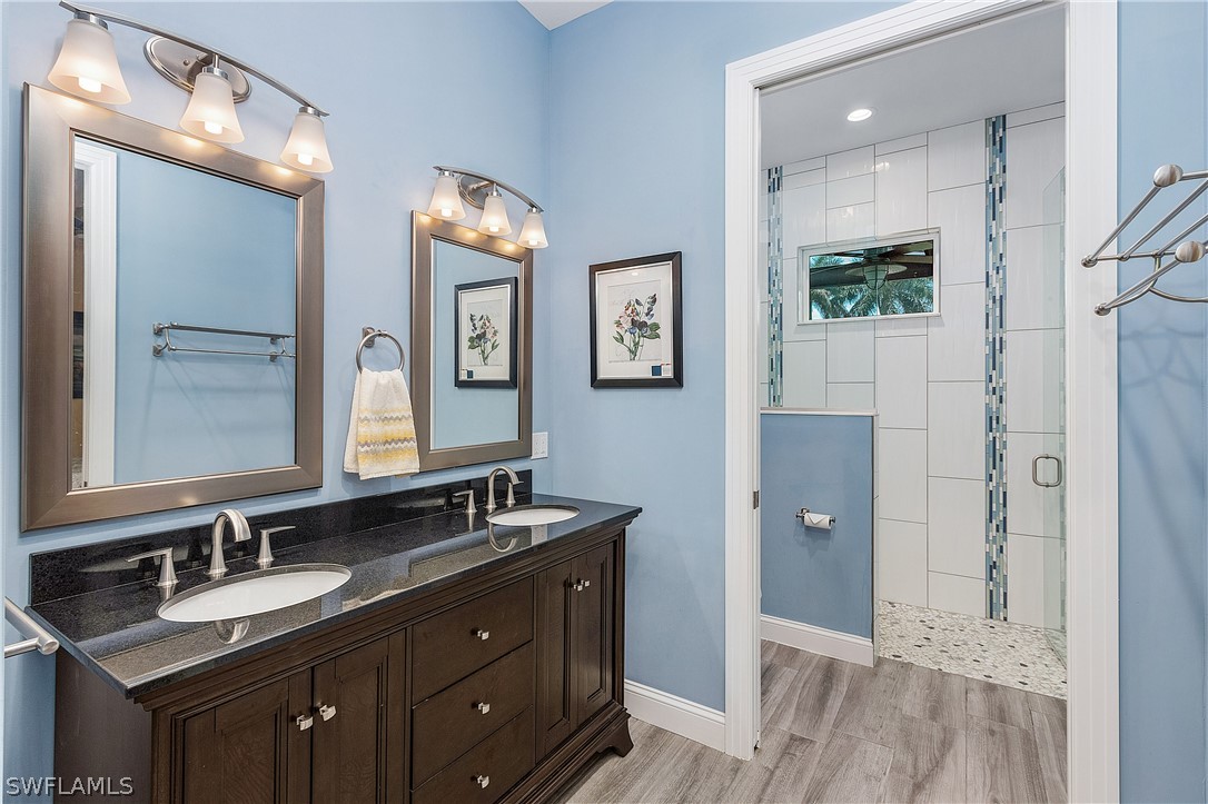 2743 Janet Street Cape Coral, FL 33993 - Photo 20 of 35 a bathroom with 2 sink and a mirror