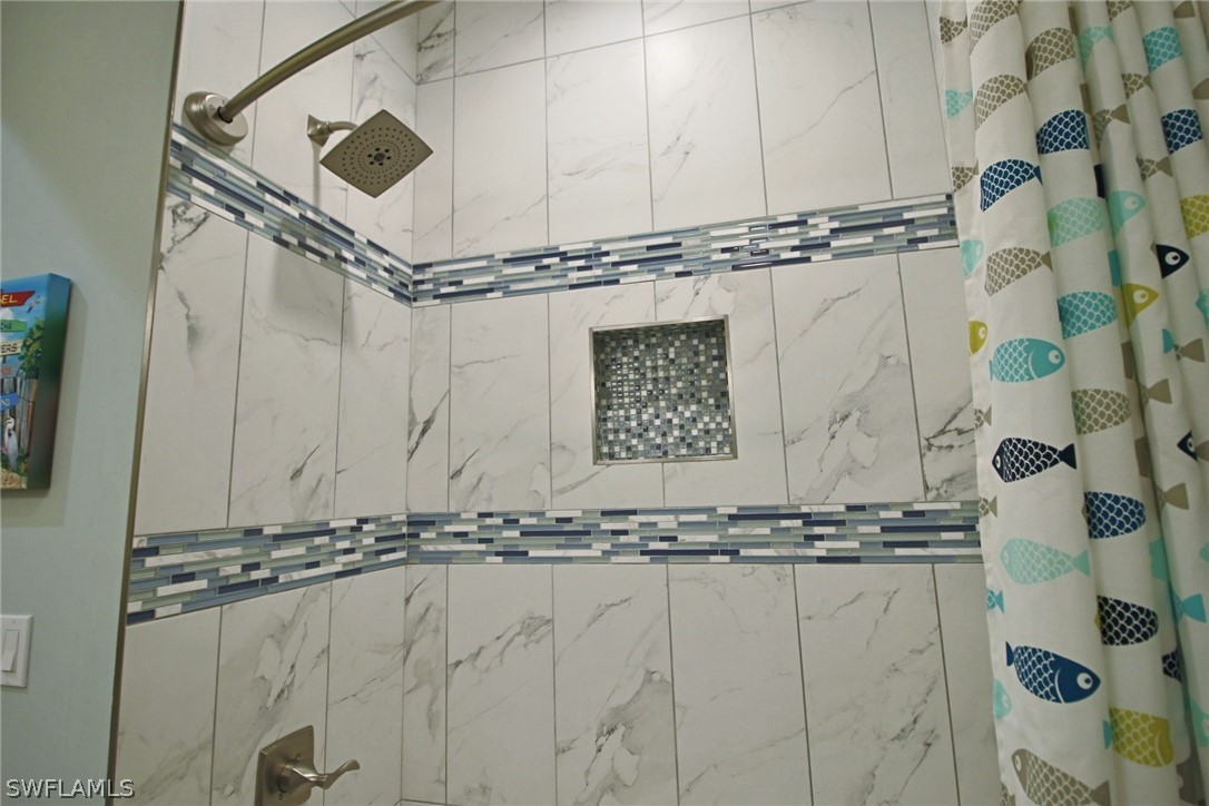 2743 Janet Street Cape Coral, FL 33993 - Photo 23 of 35 a bathroom with a granite countertop sink and a mirror