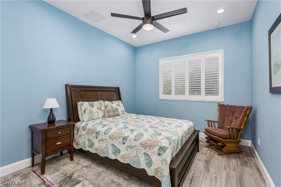 2743 Janet Street Cape Coral, FL 33993 - Photo 24 of 35 a bedroom with a bed and wooden floor