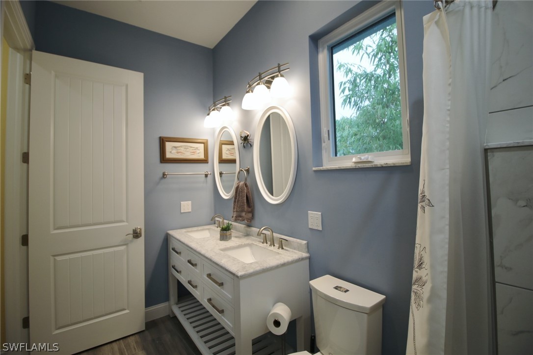 2743 Janet Street Cape Coral, FL 33993 - Photo 25 of 35 a bathroom with a double vanity sink and a mirror