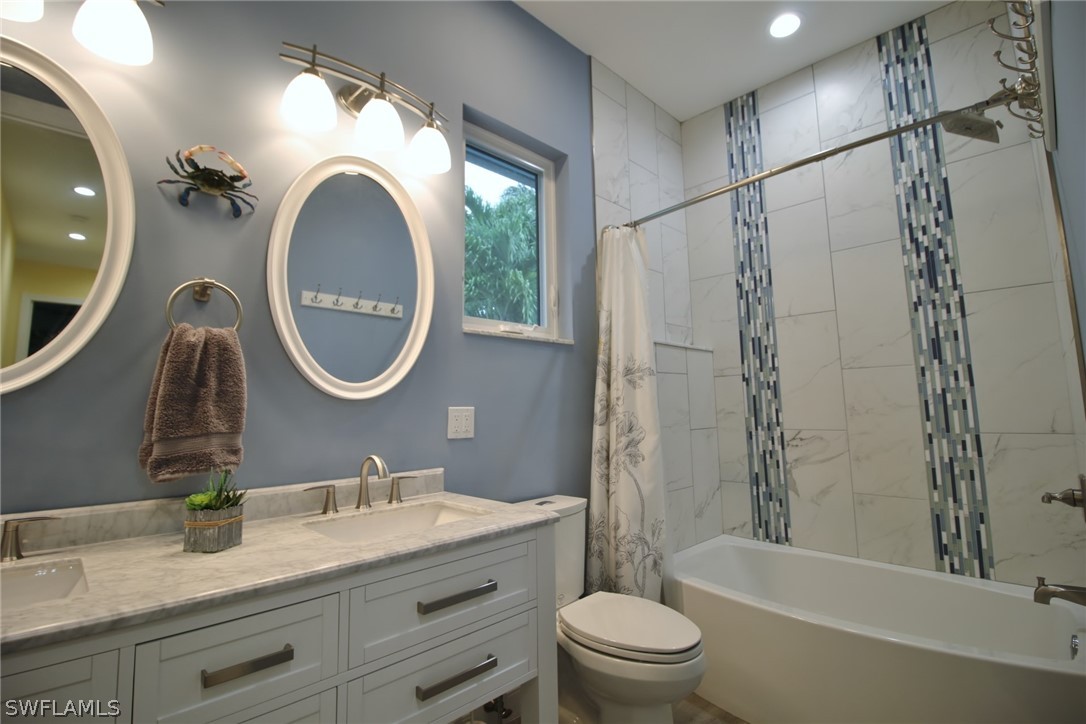 2743 Janet Street Cape Coral, FL 33993 - Photo 26 of 35 a bathroom with a granite countertop sink a toilet a mirror and shower