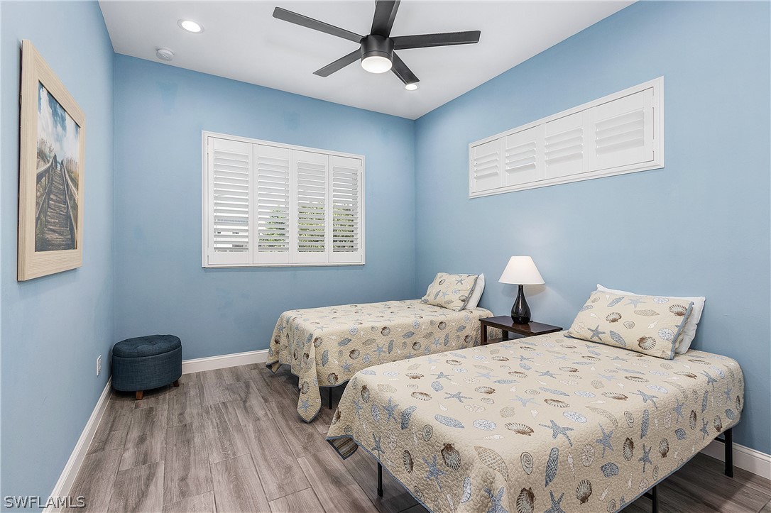 2743 Janet Street Cape Coral, FL 33993 - Photo 27 of 35 a bedroom with two beds and a ceiling fan
