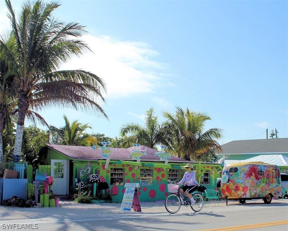 2743 Janet Street Cape Coral, FL 33993 - Photo 34 of 35 a view of street with cars and palm trees