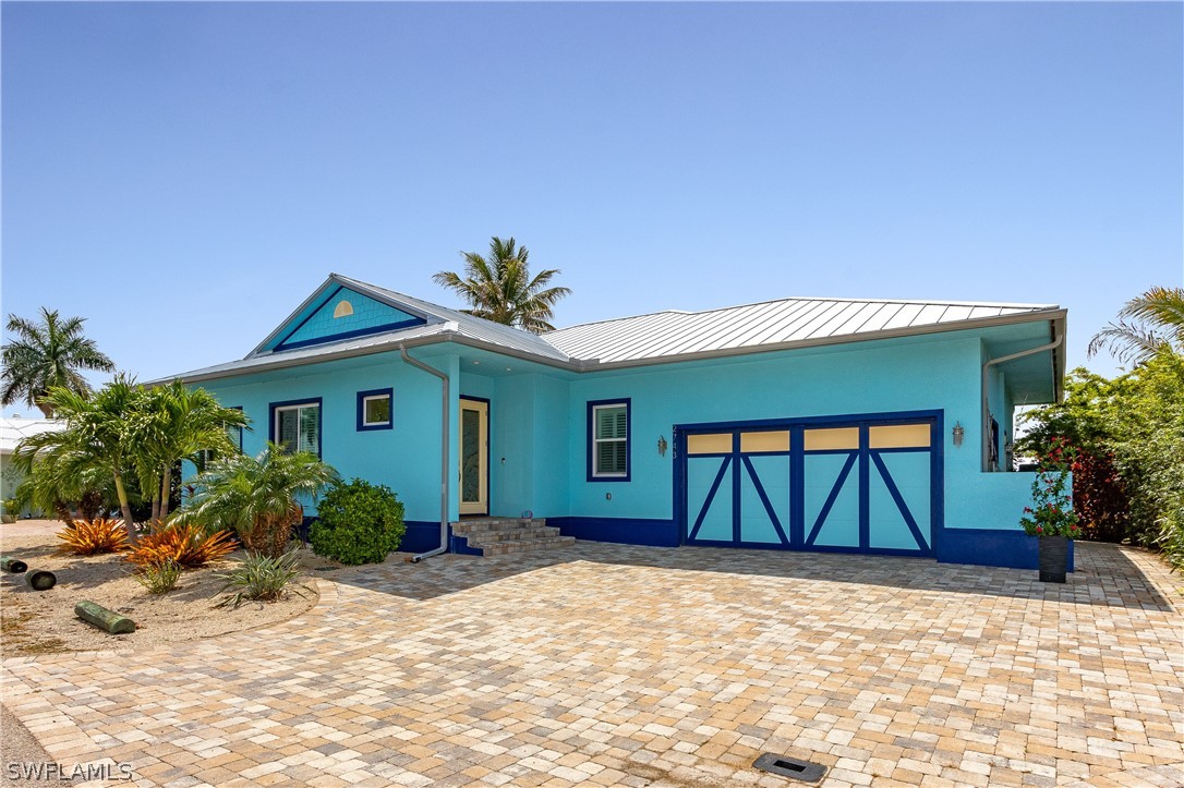 2743 Janet Street Cape Coral, FL 33993 - Photo 4 of 35 a front view of a house with garden
