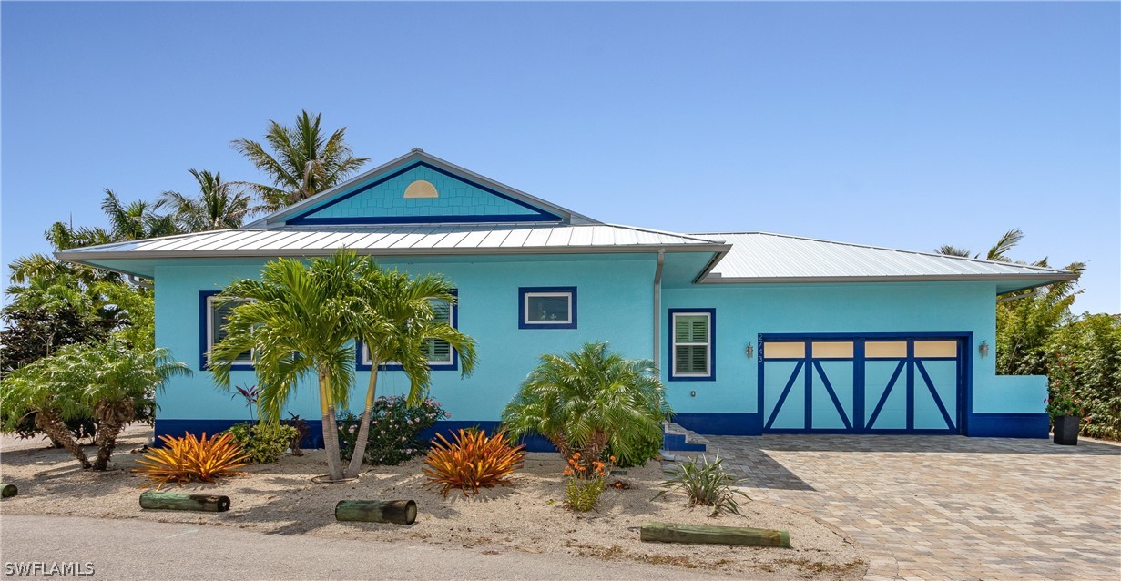 2743 Janet Street Cape Coral, FL 33993 - Photo 5 of 35 a front view of a house with garden