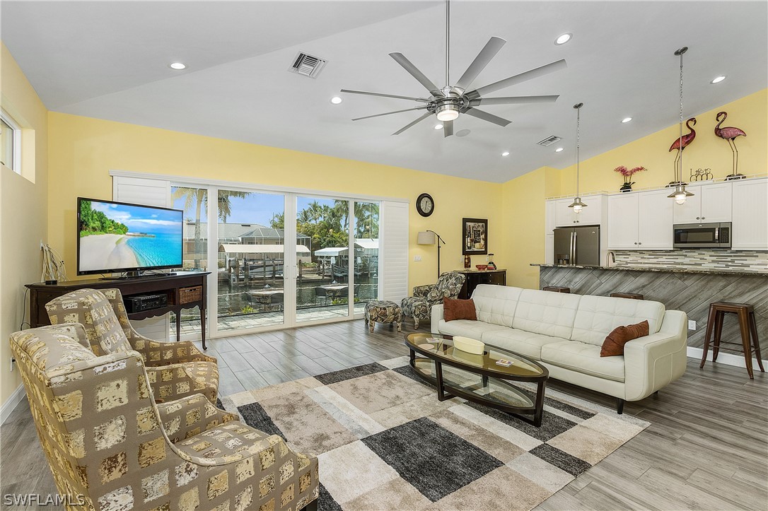 2743 Janet Street Cape Coral, FL 33993 - Photo 10 of 35 a living room with furniture and a flat screen tv