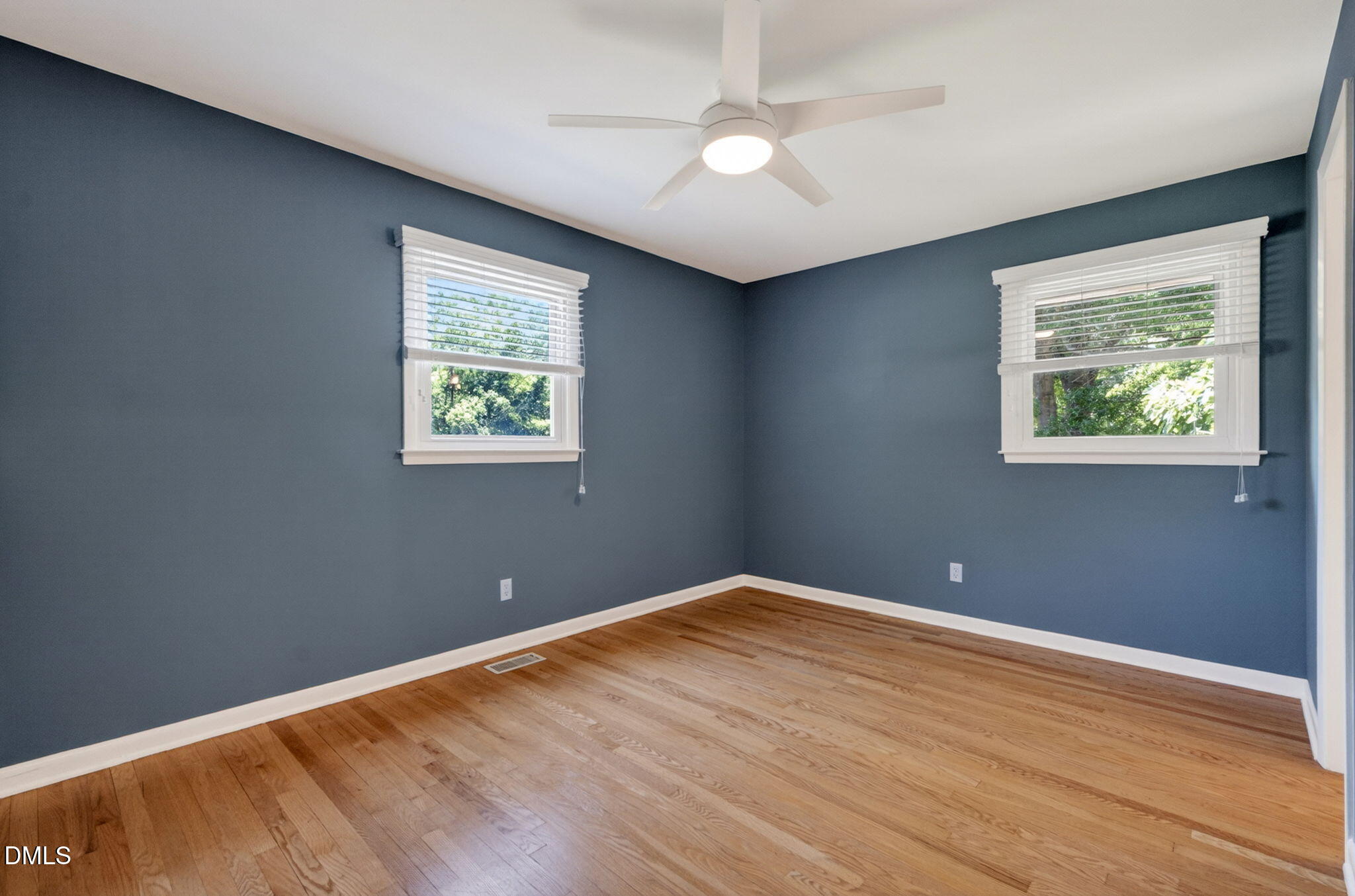 1224 Pineview Drive Raleigh, NC 27606 - Photo 19 of 45 a view of an empty room with wooden floor and a window