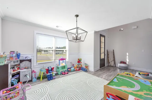 a room that has a bed and a chandelier