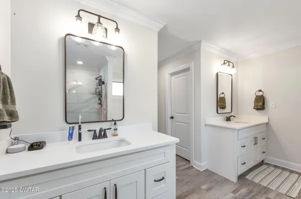 a bathroom with a sink double vanity and a mirror