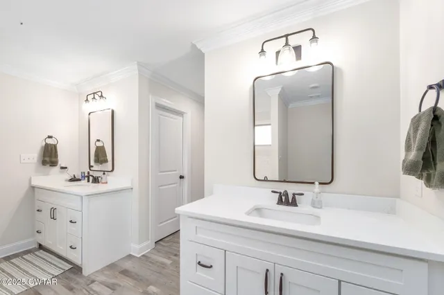 a bathroom with a double vanity sink and mirror