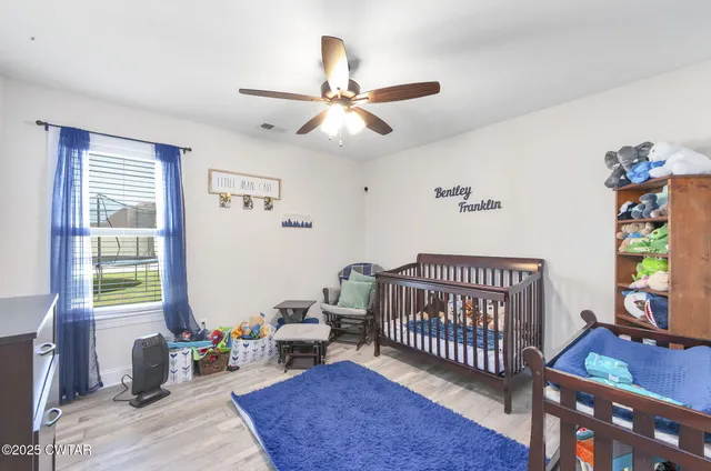 a bedroom with furniture and a window