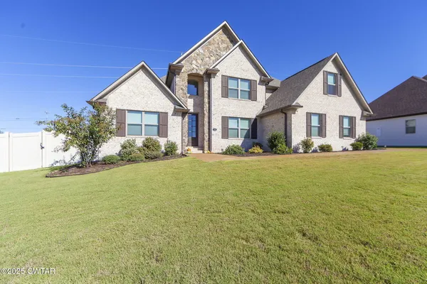 a front view of house with yard and green space