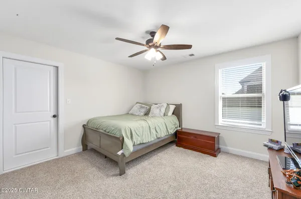a spacious bedroom with a bed and a window