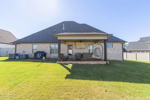 a front view of a house with swimming pool having outdoor seating
