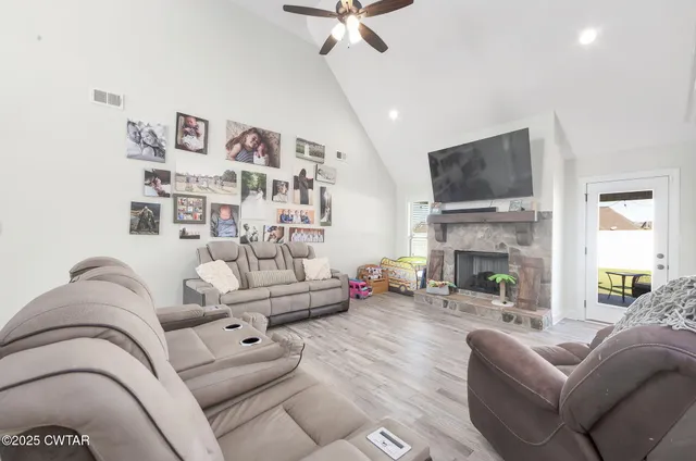 a living room with furniture fireplace and a flat screen tv