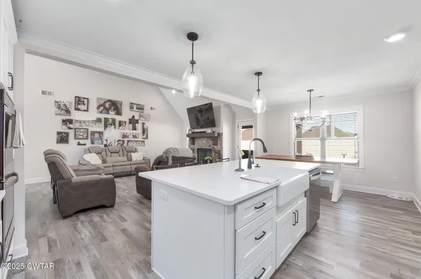 a large white kitchen with a large island