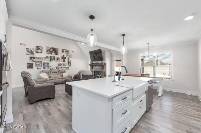 a large white kitchen with a large island