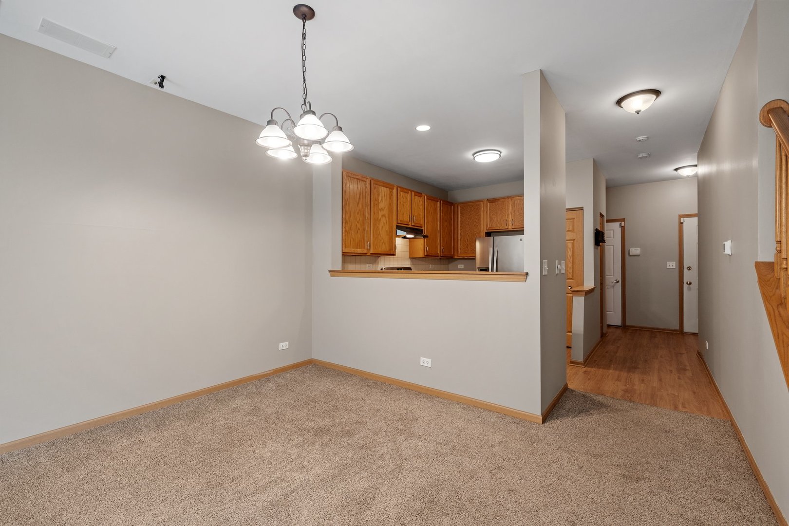 2442 Oneida Lane Naperville, IL 60563 - Photo 7 of 23 a view of a kitchen with a refrigerator a sink and a chandelier