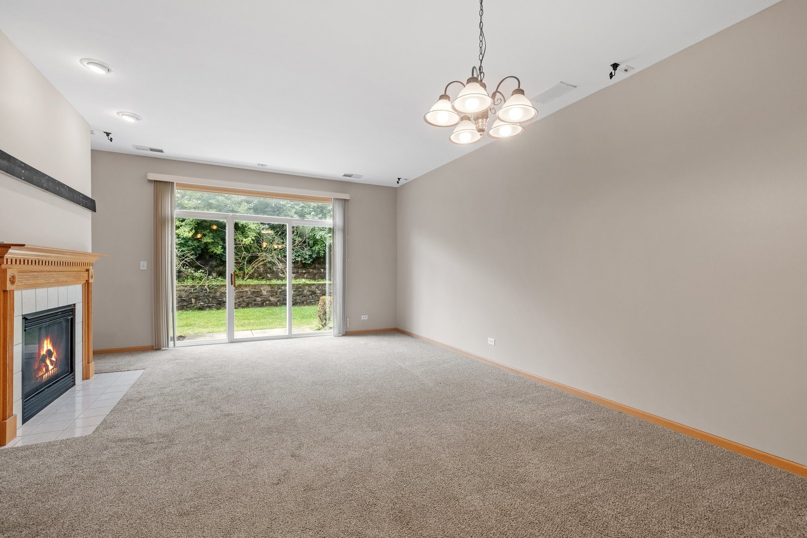 2442 Oneida Lane Naperville, IL 60563 - Photo 8 of 23 a view of an empty room with window and fire place