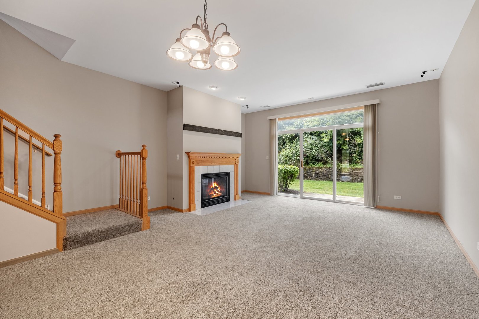 2442 Oneida Lane Naperville, IL 60563 - Photo 9 of 23 a view of an empty room with a fireplace and a window