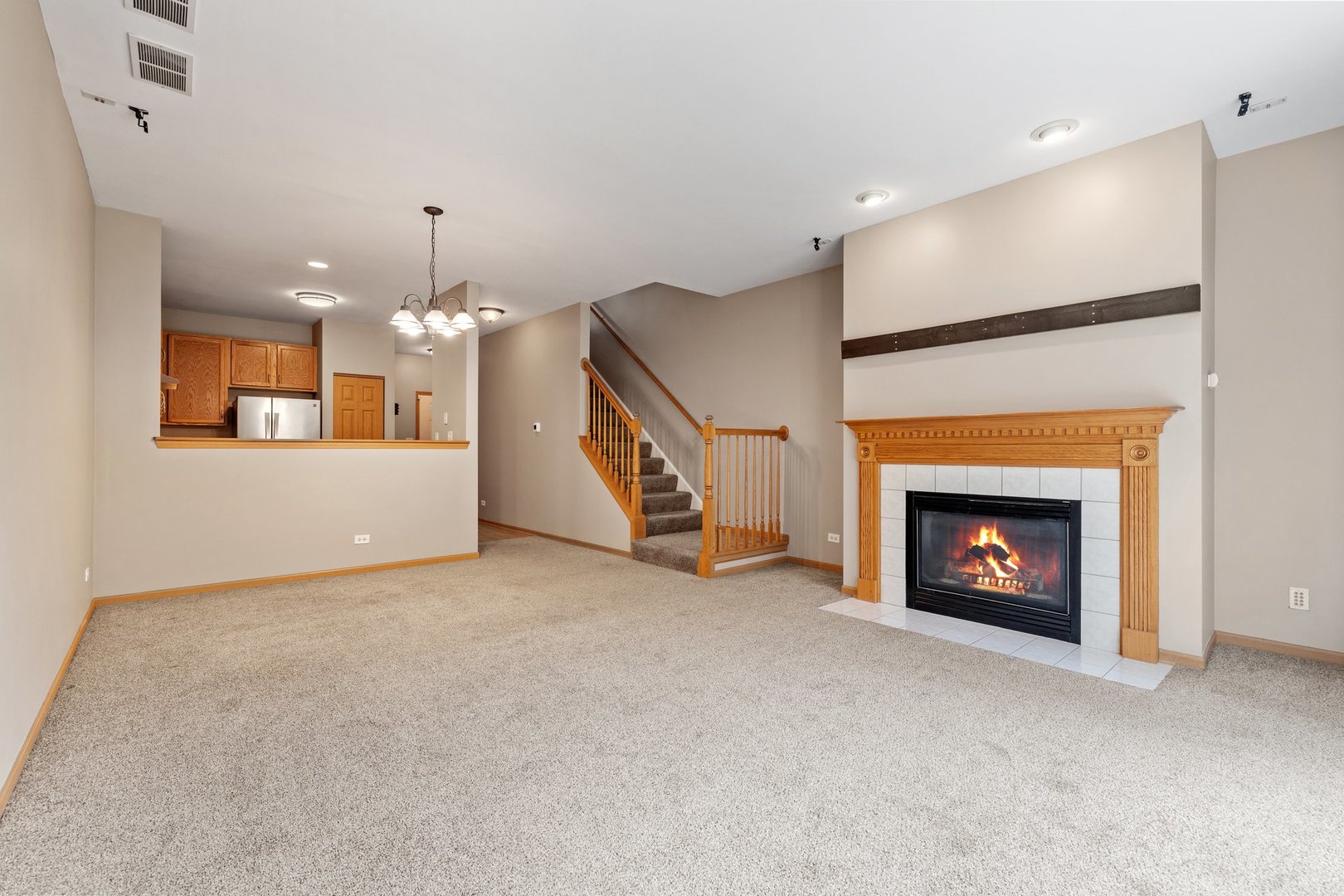 2442 Oneida Lane Naperville, IL 60563 - Photo 10 of 23 a view of a livingroom with a fireplace and stairs
