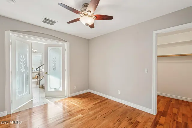 a view of empty room with wooden floor