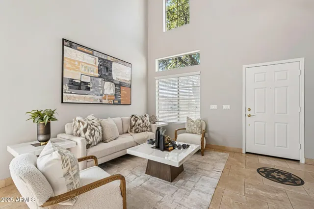 a living room with furniture and a potted plant